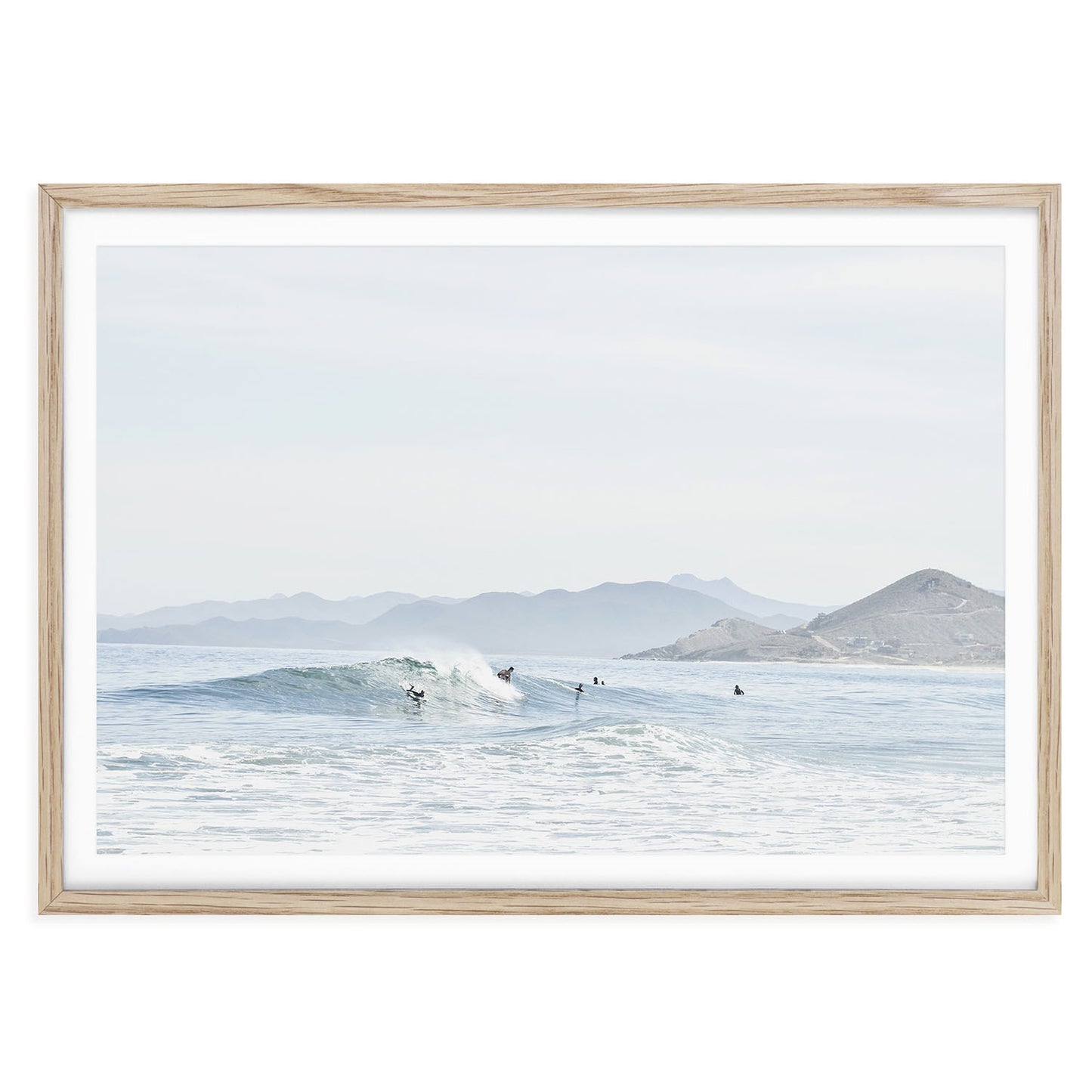 Minimalist ocean surf wall art print showing a soft wave breaking on a sandy beach in Baja California with neutral tones and natural light, framed coastal photo decor