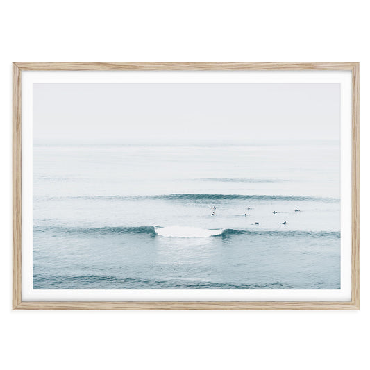Minimalist blue ocean wave photography print featuring a curling surf in natural light, coastal beach wall art, modern surf print for home or gallery decor.
