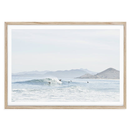 Minimalist ocean surf wall art print showing a soft wave breaking on a sandy beach in Baja California with neutral tones and natural light, framed coastal photo decor