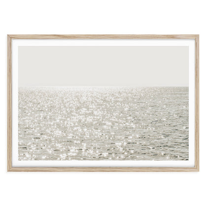 Minimalist coastal photo print featuring sparkling ocean waves under golden sunlight, capturing a serene beach scene in soft, modern tones.