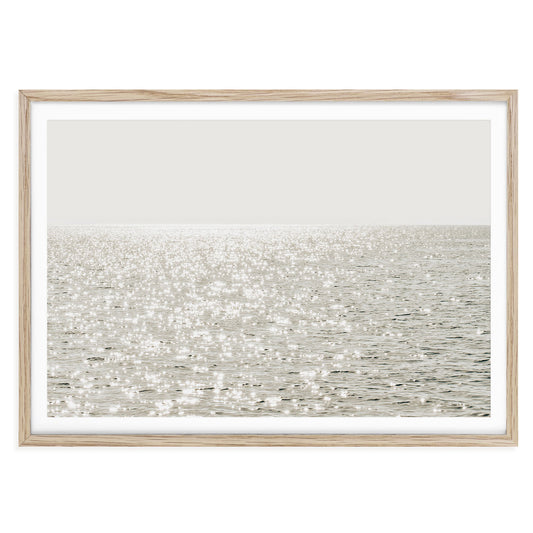 Minimalist coastal photo print featuring sparkling ocean waves under golden sunlight, capturing a serene beach scene in soft, modern tones.