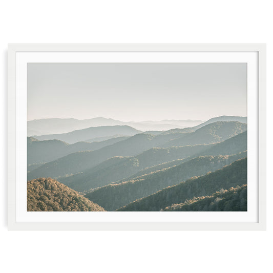 Layered smoky mountain landscape in soft neutral gray and beige tones, with atmospheric mist and gentle light minimalist fine art print for calming home decor.