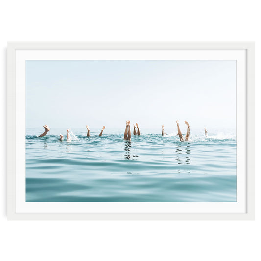 Girls doing handstand in ocean water, light airy summer swim photo, framed coastal wall art, beach photography print for serene bathroom or beach house decor.