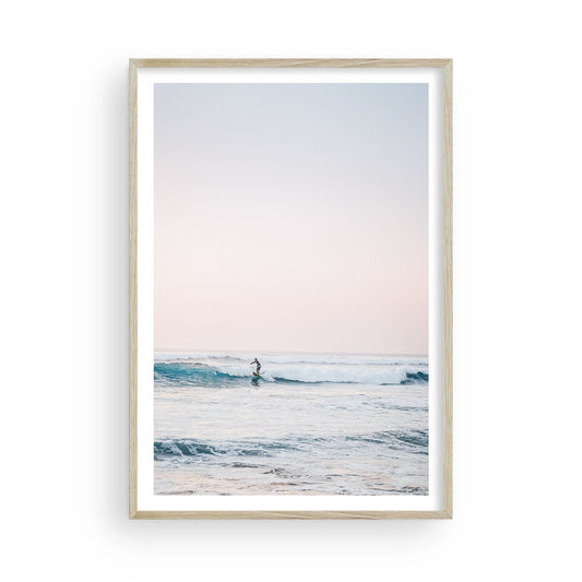 Minimalist ocean surfer fine art print featuring a lone surfer riding calm waves in a vertical composition. Neutral tones and serene energy evoke modern coastal style.