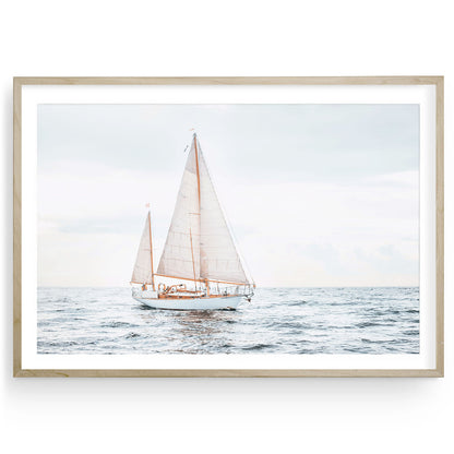 Oversized sailboat art print in modern wooden frame on plain background, minimalist coastal wall decor for beach or lake house.